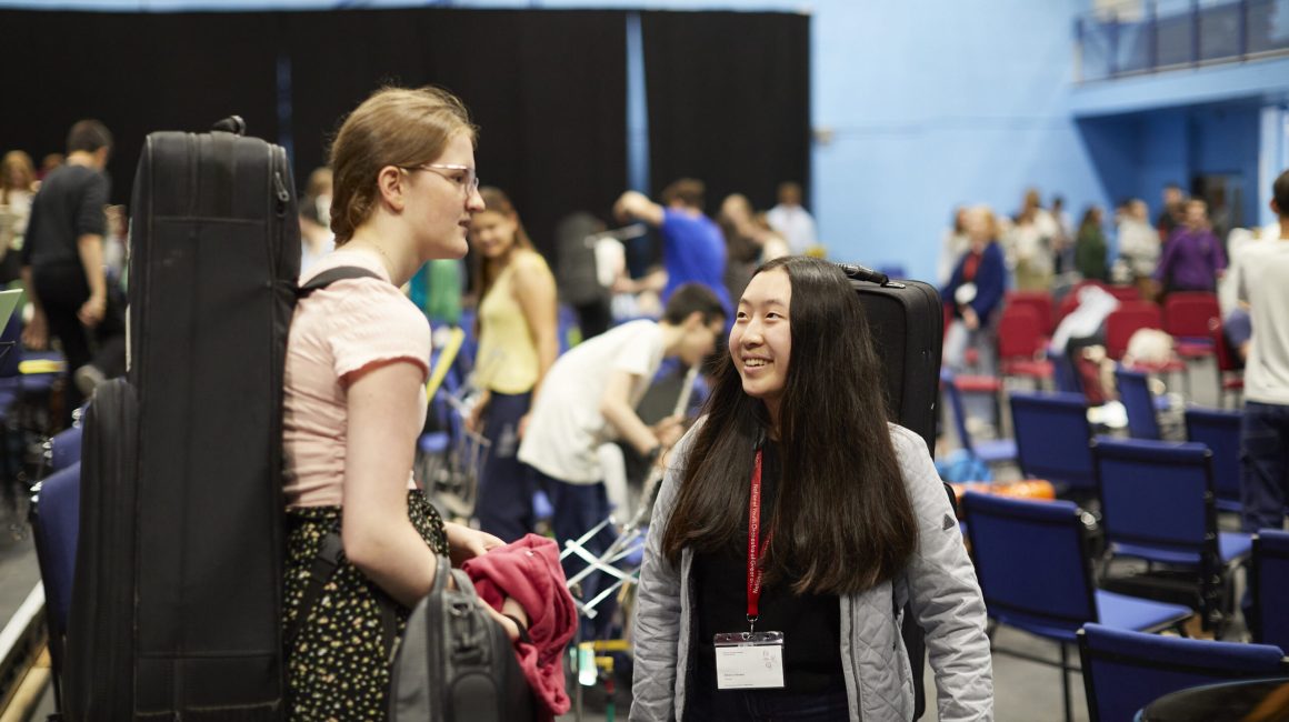 Alicia meeting another musician at a rehearsal